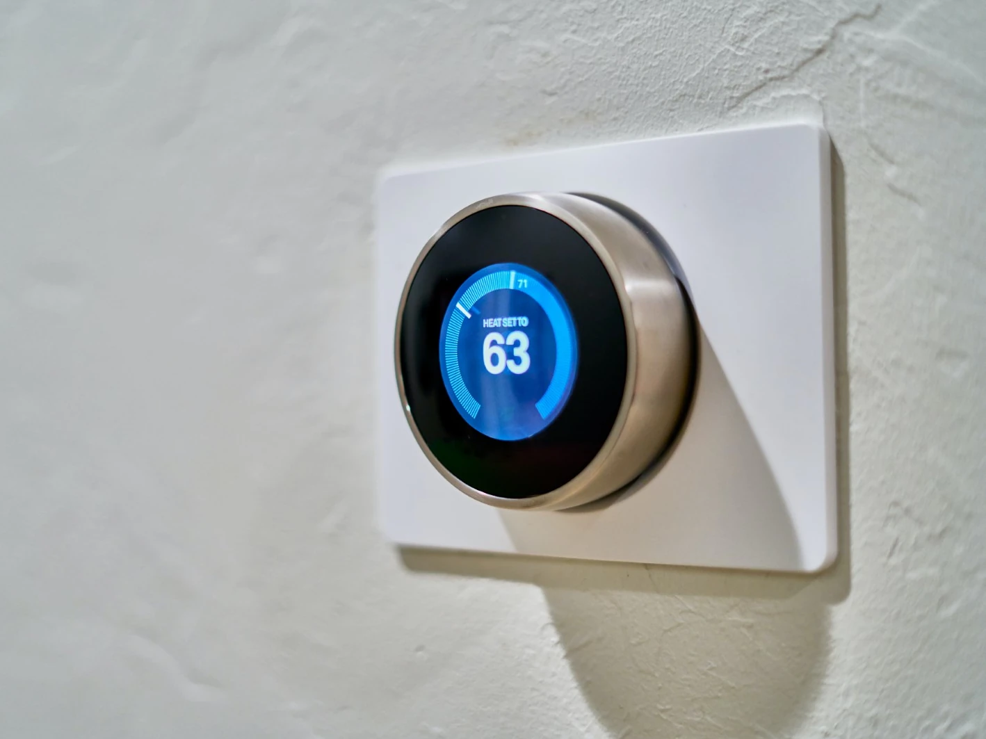 Smart thermostat mounted on wall